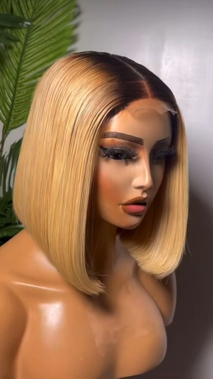 Golden-blonde straight bob with dark roots and a centre part displayed on a mannequin.