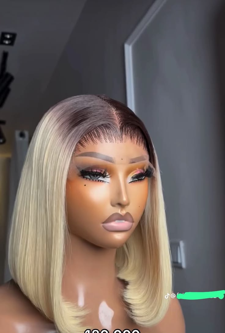 Ash-blonde straight bob with dark roots, a centre part and curved ends on a mannequin.