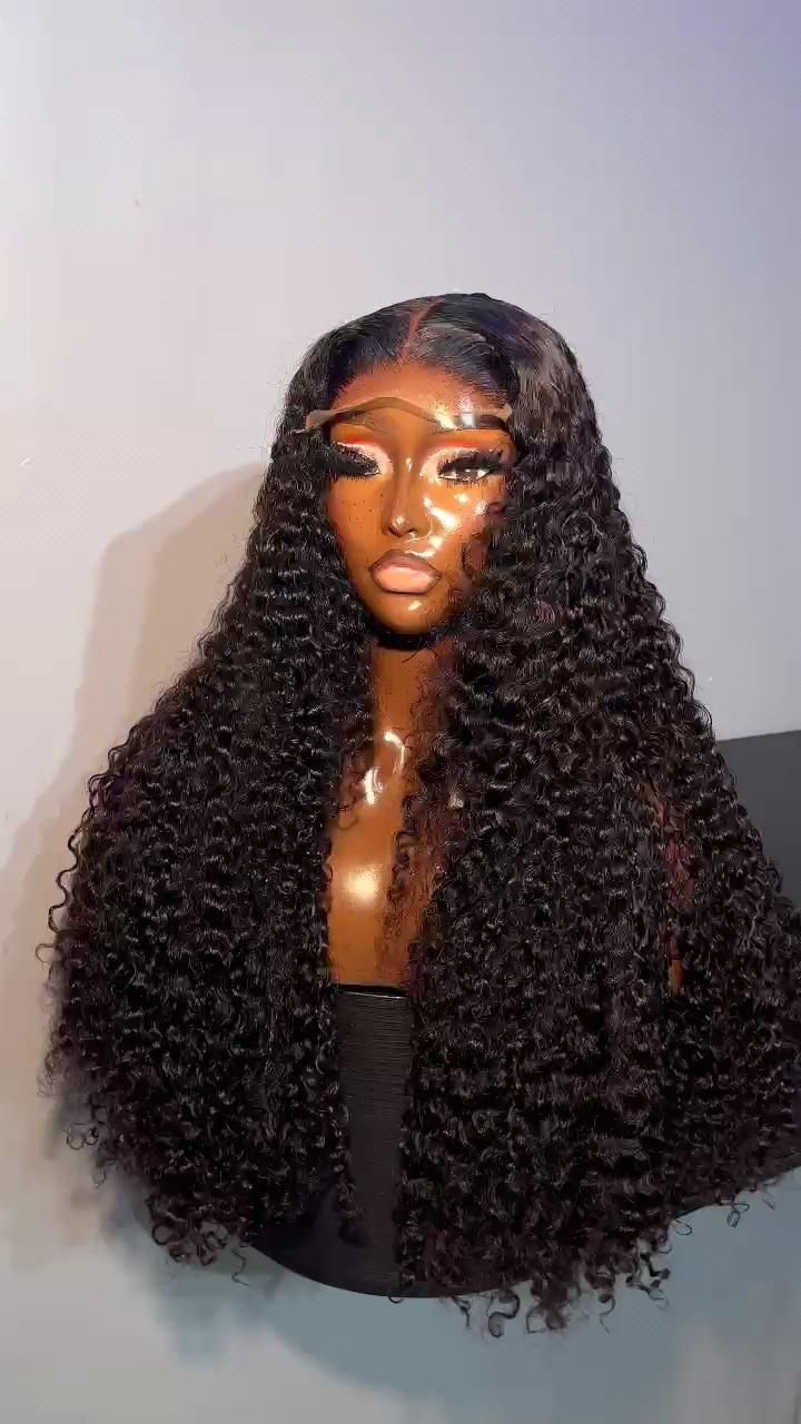 Long black wig with defined curls and a centre part displayed on a mannequin.